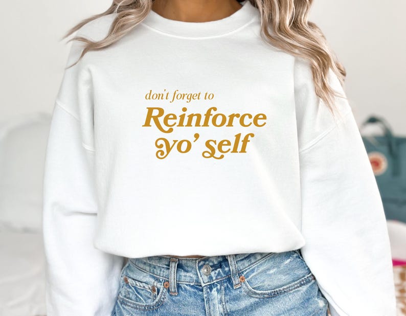 May include: White sweatshirt with a gold graphic that says "don't forget to Reinforce yo' self"