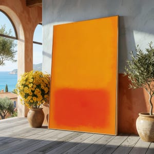 May include: A rectangular framed wall art piece featuring a vertical colour field composition with a large upper section of bright orange transitioning into a smaller lower section of deep red, enclosed in a simple light-toned wooden frame.