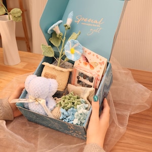 May include: A set of three ceramic mugs with a speckled, matte finish. Each mug is a different colour: light blue, cream, and grey. The mugs have a simple, modern design and a comfortable handle.