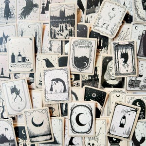 May include: A collection of rectangular stickers featuring black and white ink illustrations of various gothic and nature-themed subjects, including moons, animals, lanterns, skulls, and forest scenes, arranged in an overlapping pattern.