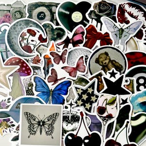 May include: A collection of assorted stickers featuring various illustrations including a black and white butterfly, a blue butterfly, a crescent moon with flowers, a teddy bear, a disco ball, a glass of cherries, a moth, and a red bow.