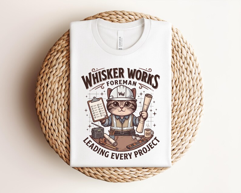 May include: White t-shirt featuring a cartoon cat in a construction worker outfit, holding blueprints and a clipboard. The text reads "Whisker Works Foreman Leading Every Project". The design includes a hard hat, tools, and a coffee mug.
