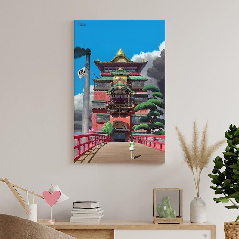 May include: A framed print of a vibrant anime scene. The artwork depicts a red building with a bridge, a person walking, and a blue sky. The text "GAMING COLLECTIBLES" is visible.