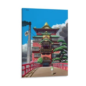 May include: A vibrant canvas print featuring a scene from the animated film, Spirited Away. The artwork depicts a red building with a green roof, a red bridge, and a character standing on the bridge. The sky is blue with clouds.