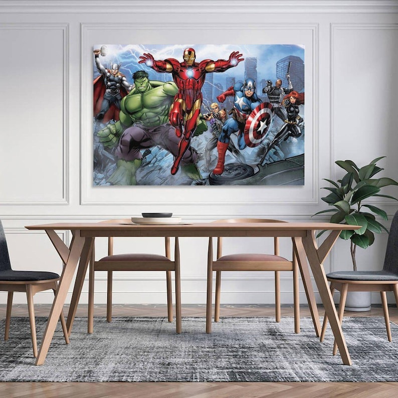 May include: A framed canvas print featuring a group of Marvel superheroes, including Iron Man, Hulk, Captain America, and Thor. The artwork has a comic book style with vibrant colors and dynamic poses. The print is displayed above a wooden dining table.