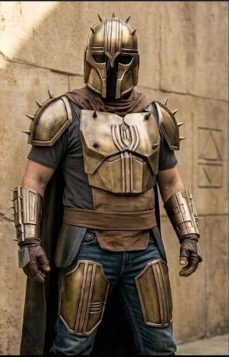 May include: A full set of metallic bronze-colored armor including a spiked helmet, chest plate, shoulder pauldrons, forearm bracers, and thigh guards. The armor is worn over a dark gray t-shirt, brown fabric wrap, and blue denim jeans.