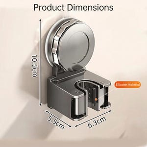 May include: A grey wall-mounted holder with a suction cup, measuring 10.5cm high, 5.5cm wide, and 6.3cm deep. The holder is made of silicone material and is designed to hold an item. The text "Product Dimensions" is at the top.