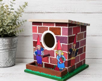 Hand painted wooden birdhouse with hand drawn then appliqued gnomes on a faux brick wall