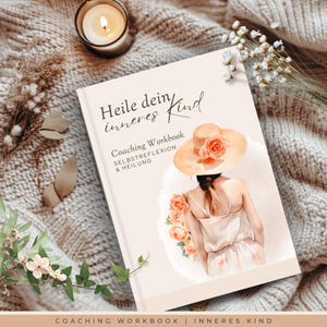 May include: A hardcover workbook titled "Heile dein inneres Kind" with a watercolour illustration of a person wearing a hat and dress, surrounded by roses. The book is on a cosy, textured blanket with a lit candle and dried flowers.