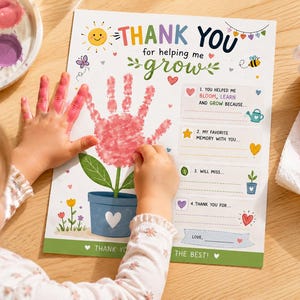 May include: A child's handprint art project on a wooden table. The print is a pink handprint over a flower illustration in a blue pot. The card reads "THANK YOU for helping me grow" with fill-in-the-blank prompts.