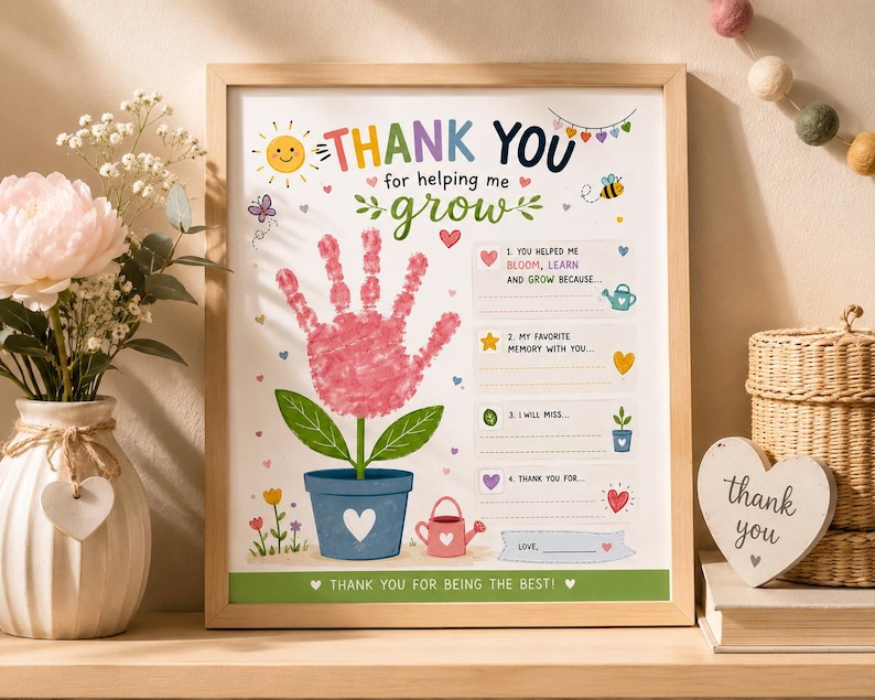 May include: A framed print with a light wood frame. The print features a handprint flower design with the words "THANK YOU for helping me grow." Includes fill-in-the-blank prompts and a heart-shaped thank you note.