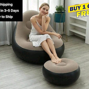 May include: An inflatable chair and footrest set. The chair is a combination of black, tan, and gray. The footrest is round and matches the chair's color scheme. The image also includes the text "BUY 1 GET 1 FREE".