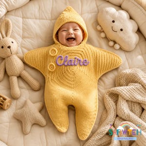 May include: A yellow knitted star-shaped baby bunting with a hood, featuring two round buttons and the name Claire embroidered in purple script. The garment is surrounded by a knitted rabbit, a smiling cloud, and a small star-shaped pillow.