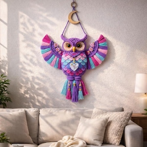 May include: A colorful owl wall hanging with outstretched wings. The owl features a purple head and body, with pink, blue, and purple wings. A wooden crescent moon hangs above the owl. A heart-shaped gem is on the owl's chest.