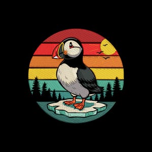 May include: An embroidered patch showing a puffin bird on an ice floe, set against a retro sunset design. The puffin has a large orange beak, black and white feathers, and is surrounded by trees and a yellow sun.
