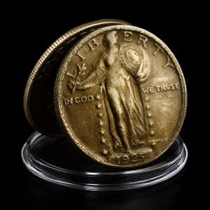 May include: Two gold-toned coins, one partially obscuring the other, are displayed on a clear plastic holder against a black background. The coins feature the word "LIBERTY" and the phrase "IN GOD WE TRUST". The year "1925" is visible.
