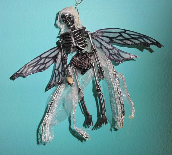 A hand-sculpted skeleton fairy ornament that merges creepy-cute with holiday decor — the kind of thing that makes someone do a double-take on the Christmas tree.