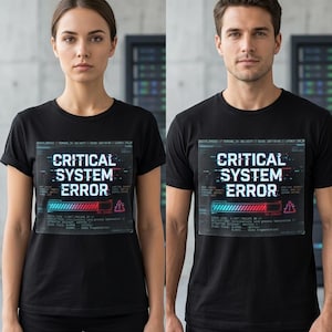 May include: Black t-shirts featuring a graphic with the text "CRITICAL SYSTEM ERROR" in white, blue, and red. The design has a glitch effect, a loading bar, and an exclamation mark. The t-shirts are short-sleeved.