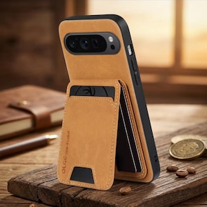 May include: A tan leather phone case with a black frame and a built-in card holder. The case is designed to hold a phone and cards, with the card holder visible on the front. The case is on a wooden surface.