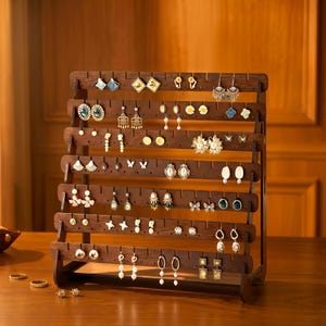 May include: A dark brown wooden earring display stand, filled with a variety of earrings. The stand has multiple horizontal rows, displaying earrings of different styles and colours. The earrings include studs, hoops, and dangling designs, showcasing a range of jewellery.