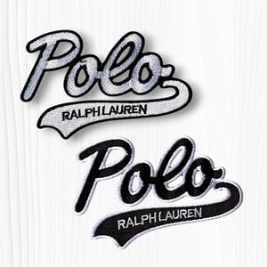 May include: Two embroidered patches with the word "Polo" in a script font, above a banner that reads "Ralph Lauren". One patch is white with black trim, the other is black with white trim.