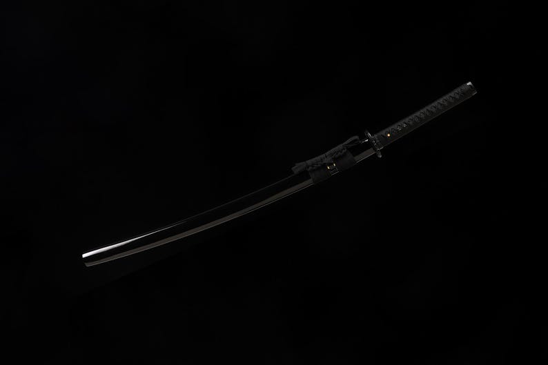 May include: A black katana sword with a curved blade. The handle is wrapped in a textured black material, and the scabbard is also black. The sword is set against a black background.