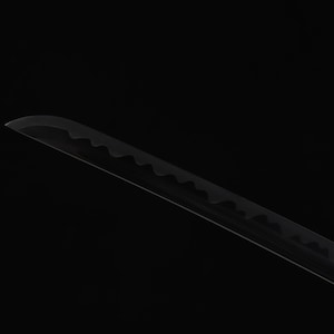 May include: A black katana blade with a curved edge and a serrated pattern along the spine. The blade is set against a black background, highlighting its sleek design and sharp details.