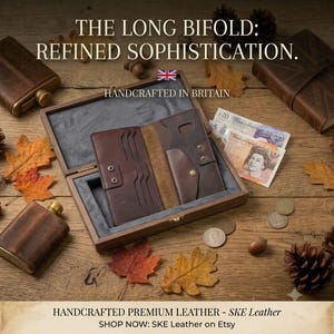 May include: A brown leather long bifold wallet with multiple card slots and a snap-button pocket, displayed inside a wooden box. The text reads: THE LONG BIFOLD: REFINED SOPHISTICATION. HANDCRAFTED IN BRITAIN. HANDCRAFTED PREMIUM LEATHER - SKE Leather.