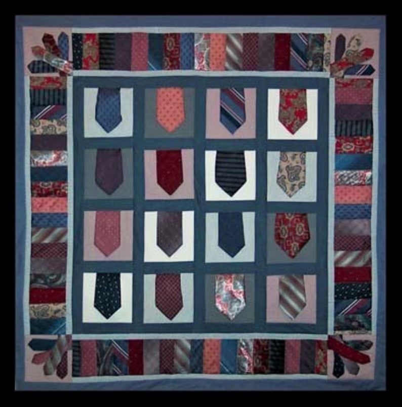 May include: A blue and white quilt with a patchwork design made from various neckties. The quilt is made up of squares with different colored and patterned ties.