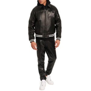 May include: Black leather jacket with a crocodile texture, white stripes on the cuffs and waist, and a logo on the chest. The jacket is paired with matching black leather pants and white sneakers. The outfit is a complete set.