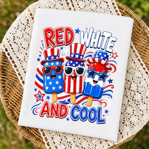 May include: A white fabric surface featuring a graphic print of three anthropomorphic popsicles wearing top hats and sunglasses. The text reads RED WHITE AND COOL. The design uses a patriotic color palette of red, white, and blue with star motifs.