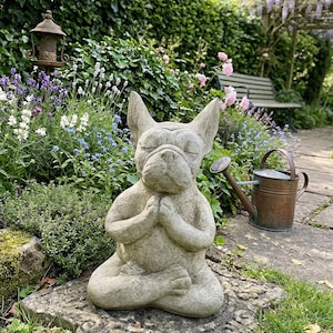Statue of a French Bulldog Meditating in a Spring Garden