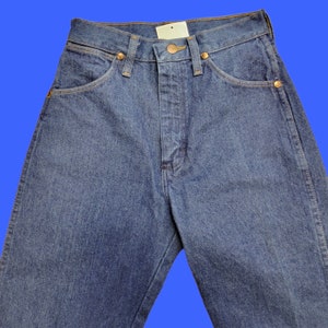 May include: A pair of dark blue denim jeans with a high waist and a straight leg.