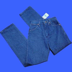 May include: A pair of blue denim jeans with a straight leg fit. The jeans have a classic five-pocket design and a button fly.