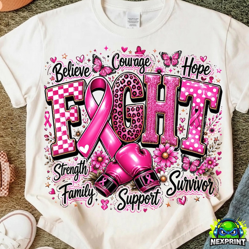 May include: A white t-shirt featuring a graphic design with the word FIGHT in large letters, a pink awareness ribbon, and two pink boxing gloves. The design includes butterflies, flowers, and the words Believe, Courage, Hope, Strength, Family, Support, Survivor.