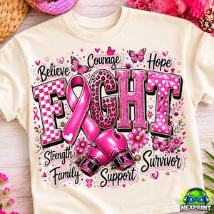 May include: A cream-colored t-shirt featuring a graphic design with the word FIGHT in large pink letters, a pink awareness ribbon, and boxing gloves. The design includes butterflies, flowers, hearts, and the words Believe, Courage, Hope, Strength, Family, Support, and Survivor.