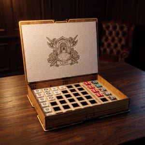 May include: A wooden game box with an open lid featuring a white textured panel with a laser-engraved shield, crossed halberds, and the word QUEST. The interior contains a grid tray holding white square tiles with skull icons and red and blue dice.
