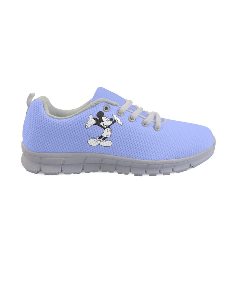 May include: A light blue trainer with a Mickey Mouse cartoon image. The shoe has grey soles, trim, and laces. The design is for comfort and casual wear. The shoe is suitable for everyday activities.