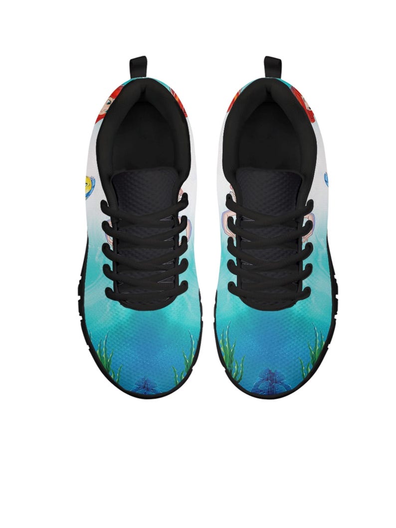 May include: A white ceramic mug with a black handle and the text "But First, Coffee" in a bold, black font. The mug is displayed on a white surface, highlighting its simple design.