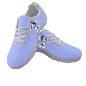 May include: A pair of light blue athletic shoes featuring a Mickey Mouse graphic. The shoes have grey soles and laces. The shoes are approximately 25 cm long.