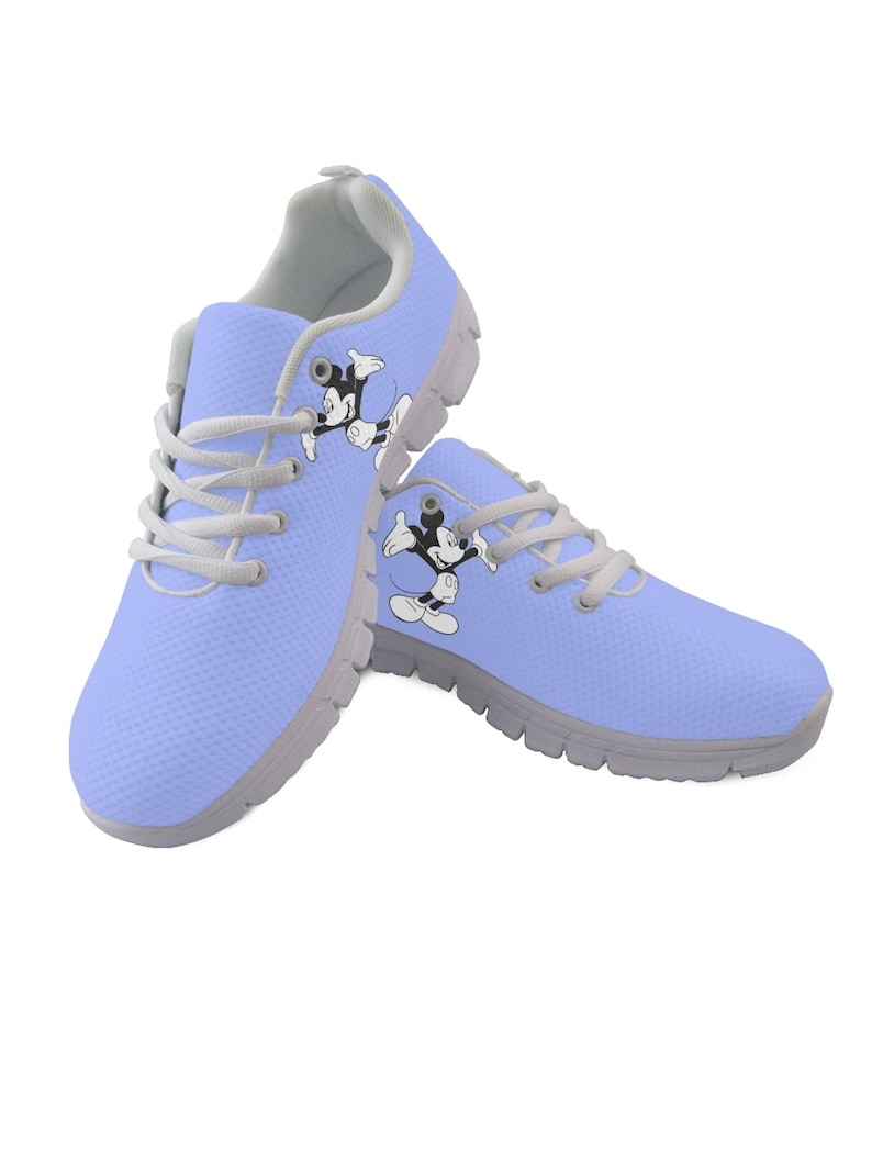 May include: A pair of light blue athletic shoes featuring a Mickey Mouse graphic. The shoes have grey soles and laces. The shoes are approximately 25 cm long.