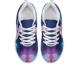 May include: A pair of athletic shoes with a vibrant galaxy design. The shoes feature a dark blue upper with a purple and blue nebula pattern. White laces and a white interior complete the design. The shoes are designed for comfort and style.