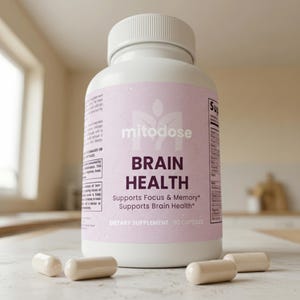 May include: A white bottle of "mitodose" dietary supplement for brain health, with the text "BRAIN HEALTH" and "Supports Focus & Memory." Several beige capsules are scattered around the bottle. The bottle contains 60 capsules.