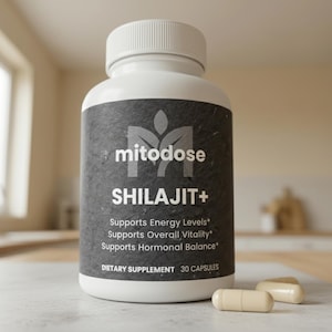 May include: A white bottle of "mitodose SHILAJIT+" dietary supplement with a black label. The label includes text that says "Supports Energy Levels", "Supports Overall Vitality", and "Supports Hormonal Balance". Two capsules are next to the bottle.