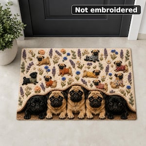 May include: A rectangular doormat featuring a print of multiple pug dogs and floral patterns. The text "Not embroidered" is visible at the top. The design includes several small pugs in sweaters and five larger pugs peeking from underneath a blanket-like fold at the bottom edge.
