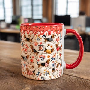 May include: A white ceramic mug featuring a repeating pattern of beagle dogs wearing jumpers, interspersed with colourful flowers, hearts, and butterflies. The top rim and handle are bright red, with a decorative red drip-style border design.