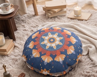 Round decorative cushion with blue and orange floral mandala pattern