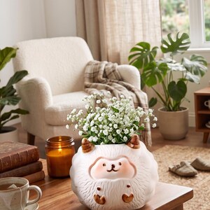 Maceta de cerámica con forma de erizo y suculenta decorativa.