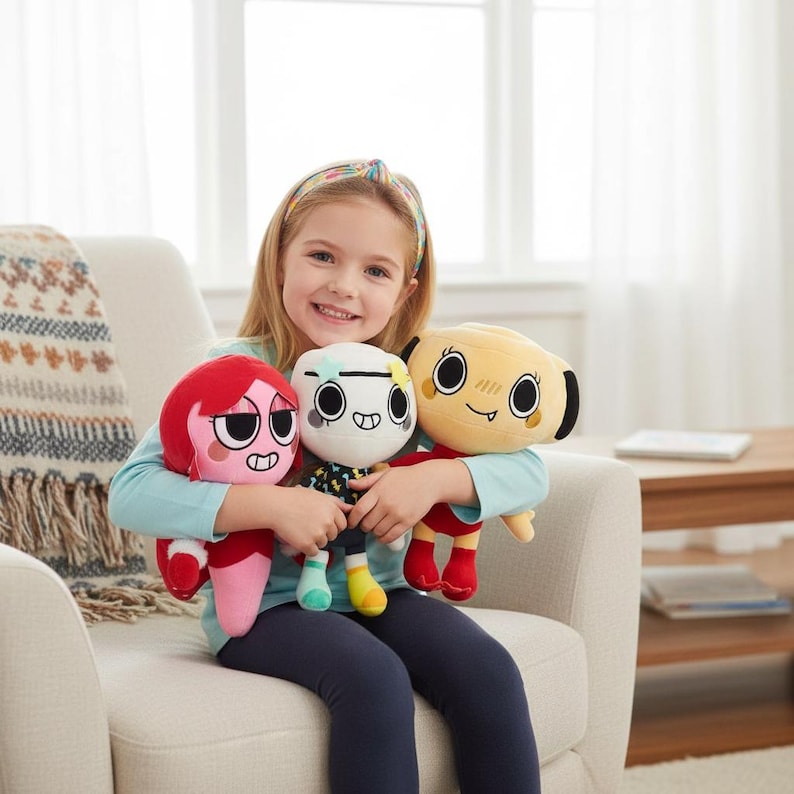 May include: Three plush toys featuring stylised cartoon characters. One is bright red with large eyes, one is white with a patterned shirt and star hair clips, and one is tan with black ears and a small tooth. Each has a distinct facial expression.