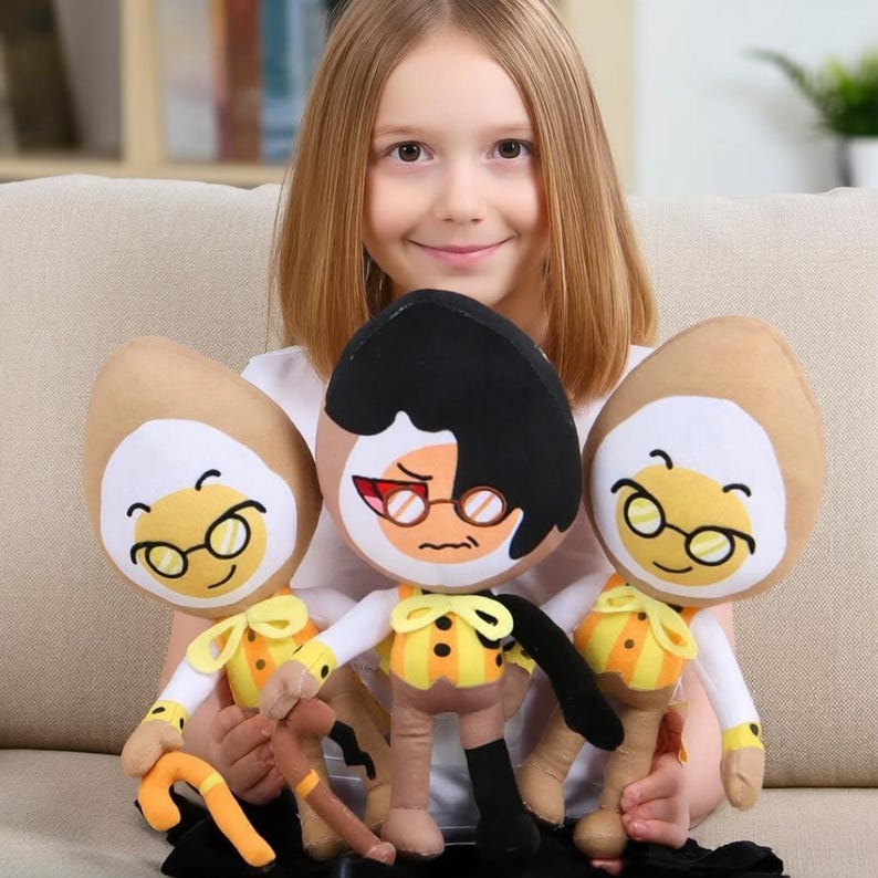 May include: Three plush toys featuring cartoon characters with egg-shaped heads. Two characters have tan heads, round glasses, and yellow striped vests. The central character has black hair, red-tinted glasses, a yellow striped vest, and a cane.